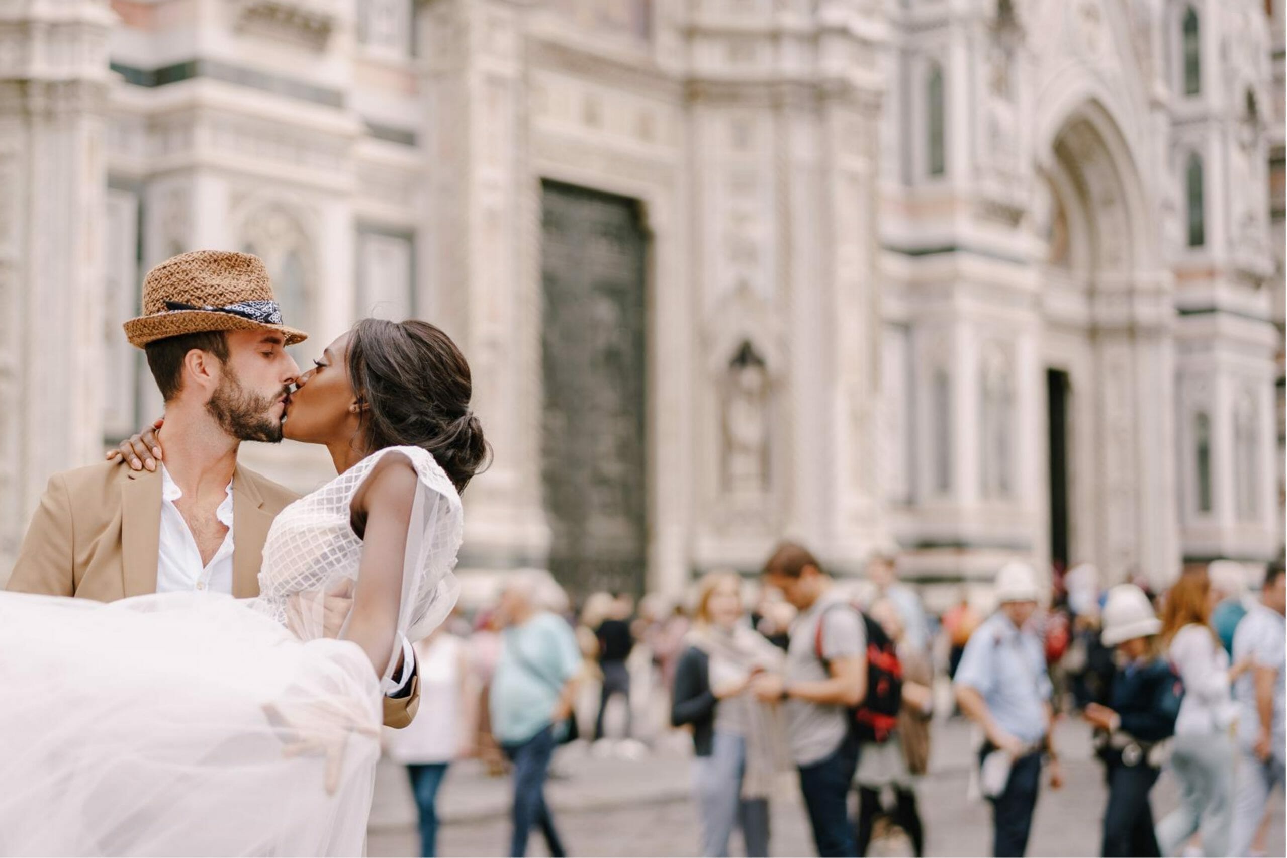 Couple kissing in front of tourists