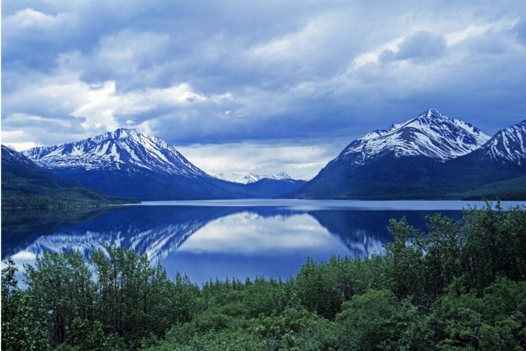 Clear lake with mountains either side in Alaska