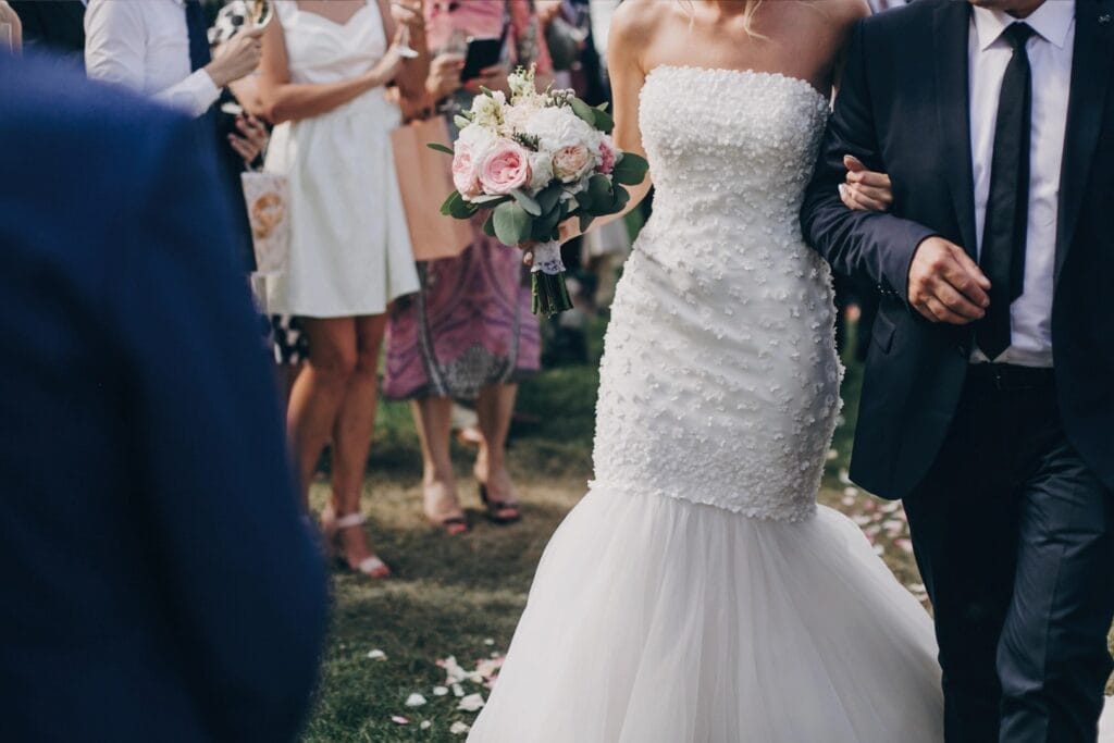Best wedding songs (2) Bride with bouquet walking arm in arm