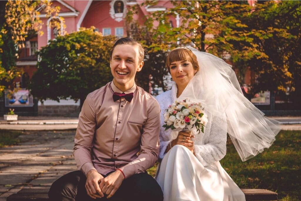 Fall bride dress and groom suit A bride wearing a fall wedding dress and a groom wearing an autumn wedding suit